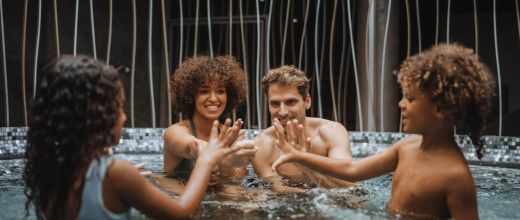 Famille jouant dans un bassin d'eau thermale